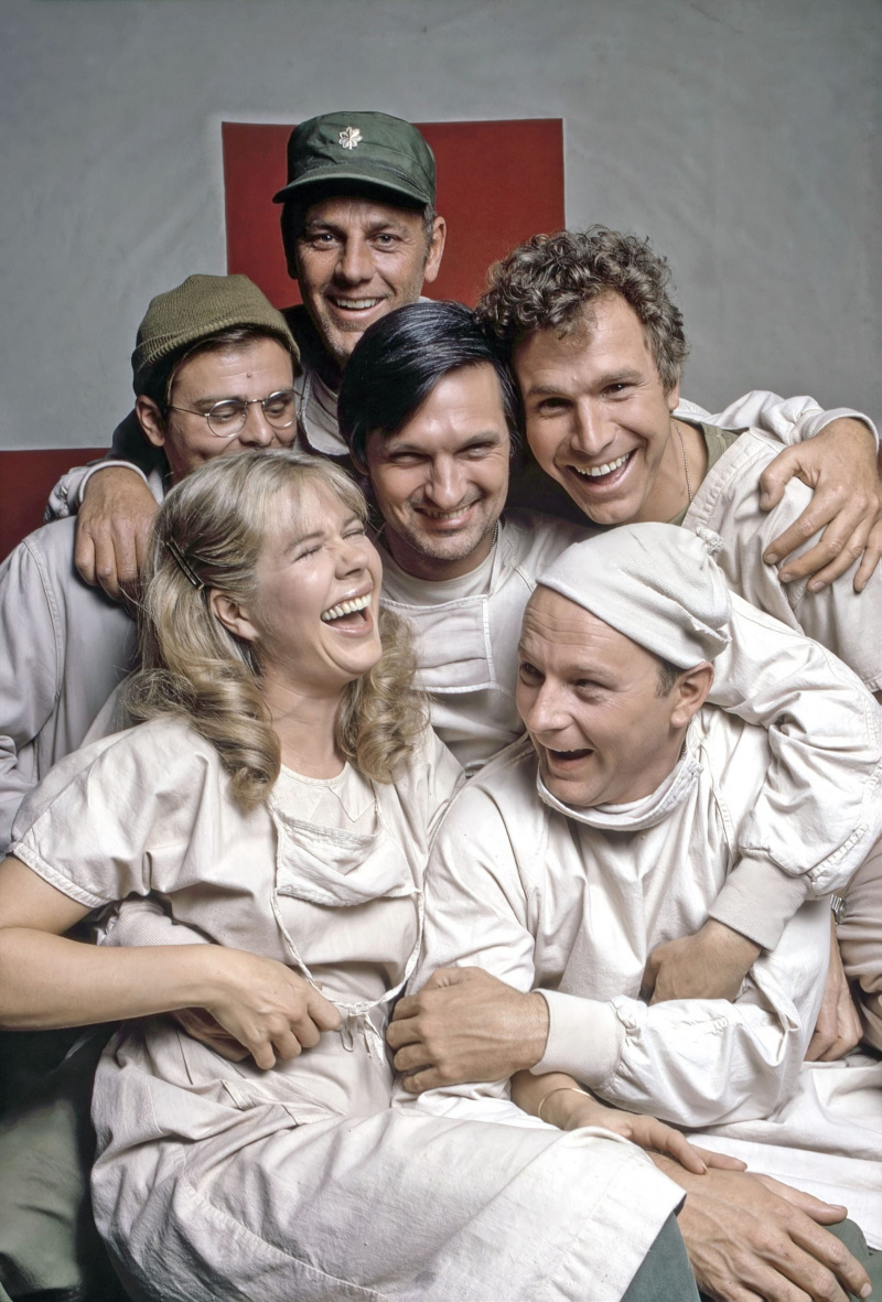   MASH (dar žinomas kaip M*A*S*H*), pagal laikrodžio rodyklę iš viršaus į kairę: Gary Burghoff, McLean Stevenson, Alanas Alda, Wayne'as Rogersas, Larry'is Linville'is, Loretta Swit, 1973 m.